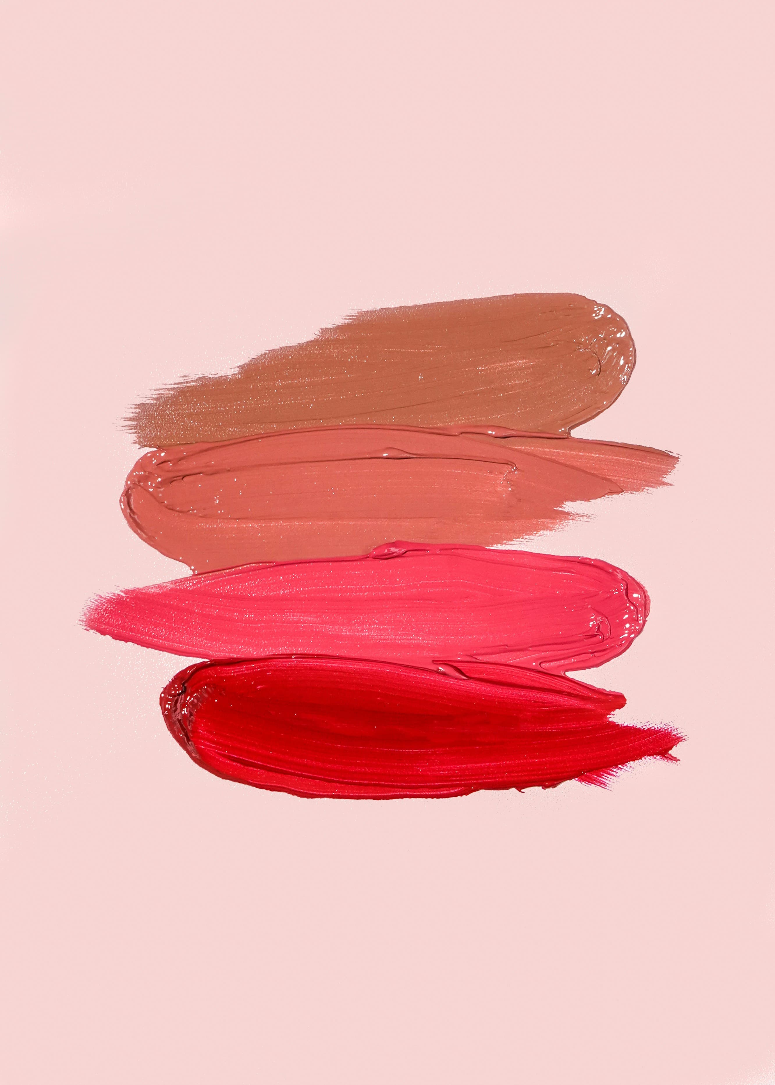 Swatches of paint in warm and red tones